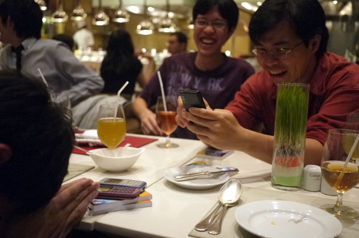 a group of men sitting around a table talking