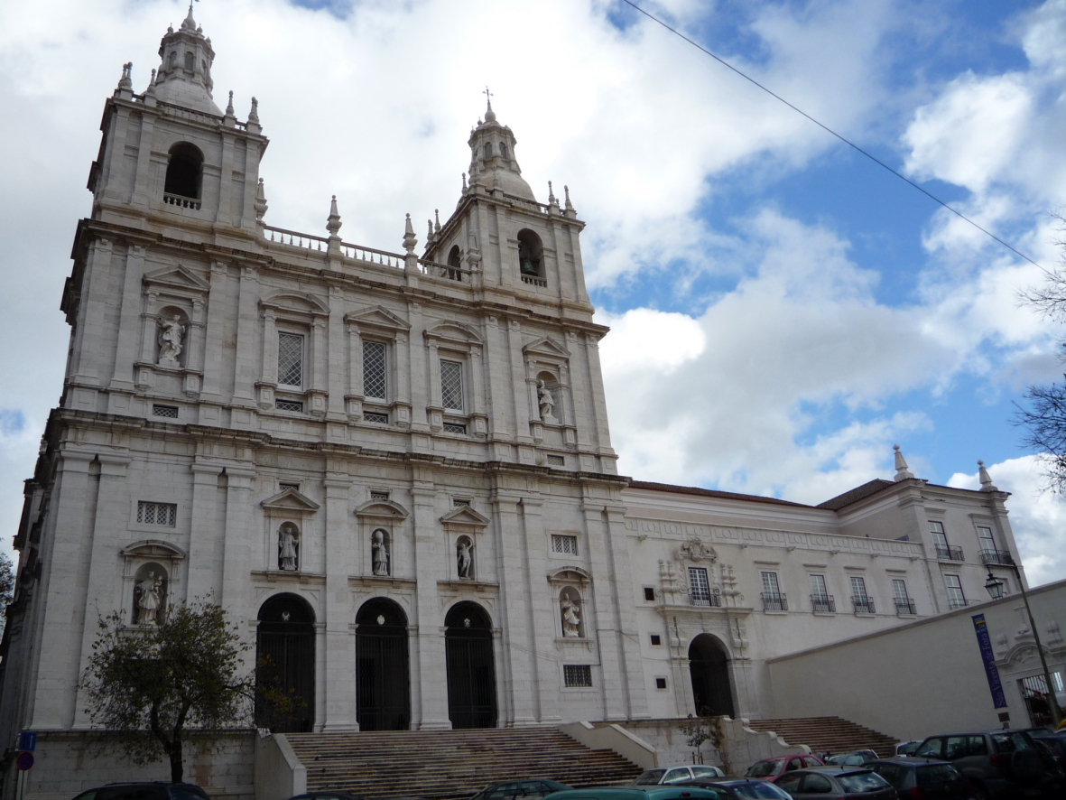 a large white building with steeples and windows