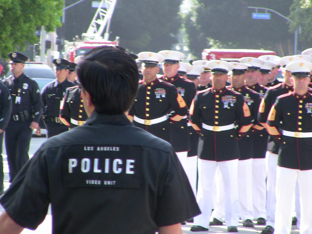 men in military dress uniforms walking down the street