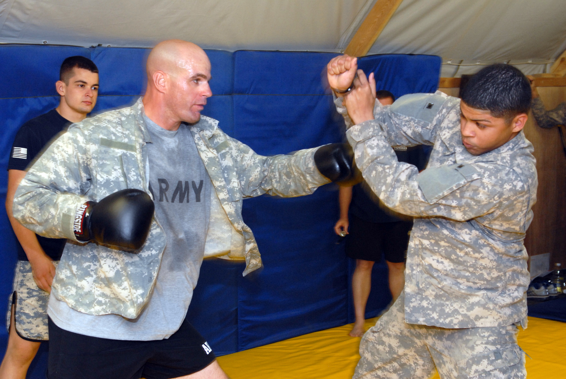 men in camouflage boxing at the army base