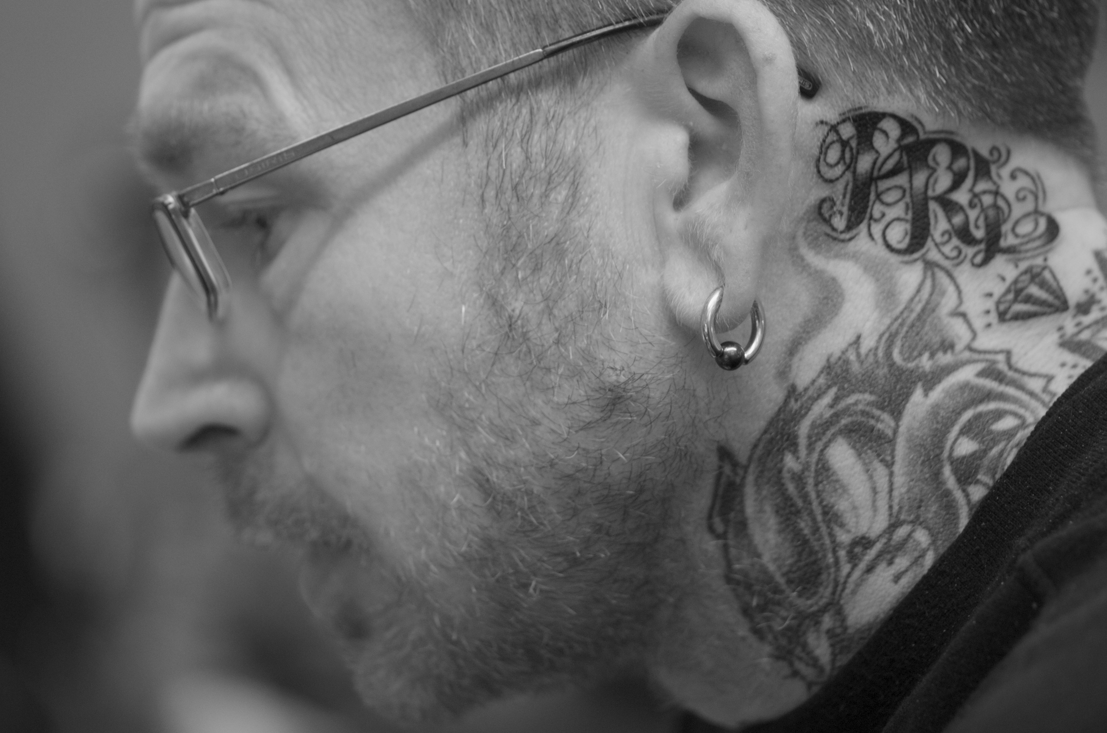 a man with a tattoo is staring into the distance