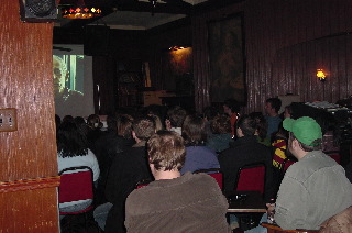 several people sit in rows while watching some kind of film