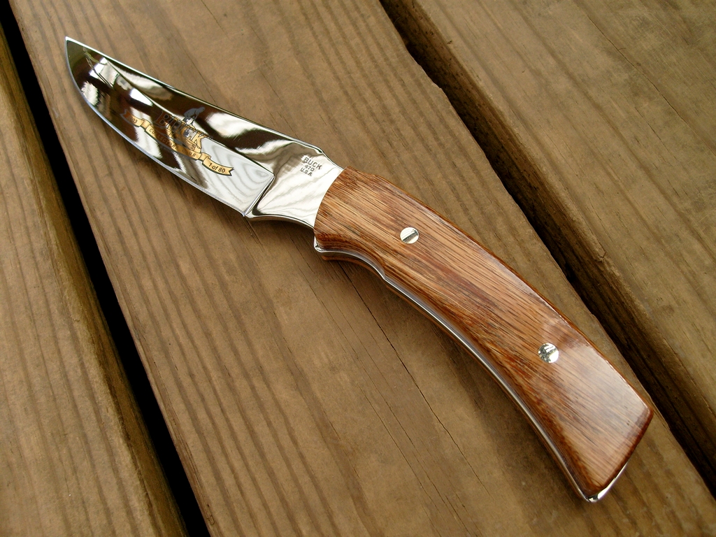 a knife laying on top of a wooden surface