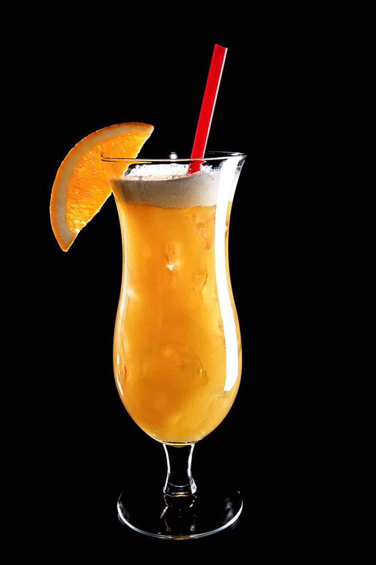 orange drink in glass with straw on top