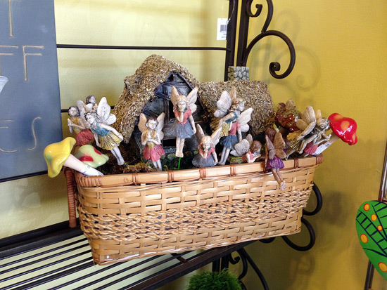 there are figurines in a basket next to a statue