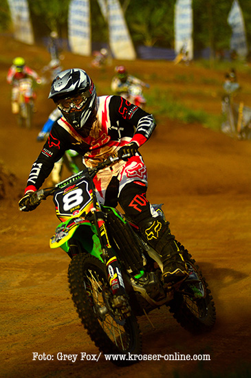 a person riding a motorcycle down a dirt track