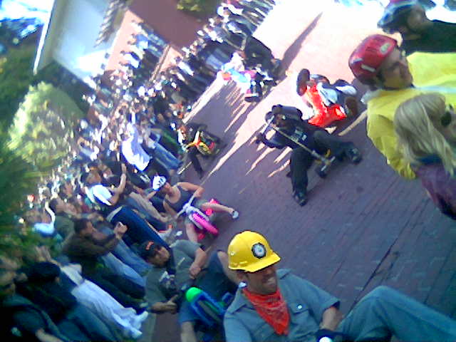 several people sitting on benches and some people wearing hard hats
