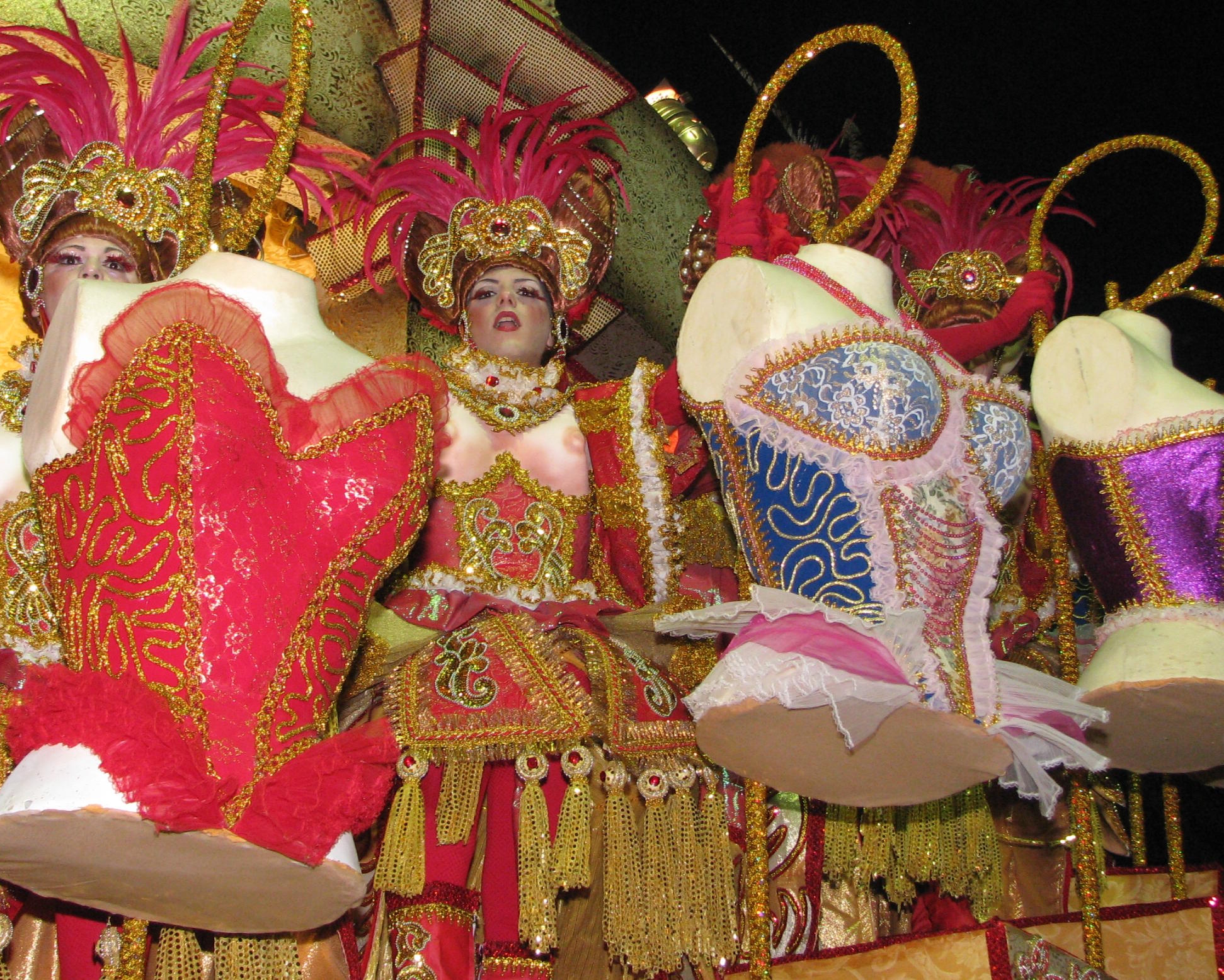 several women are dressed in fancy garb at the carnival