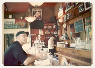 a man sitting at a counter in a restaurant