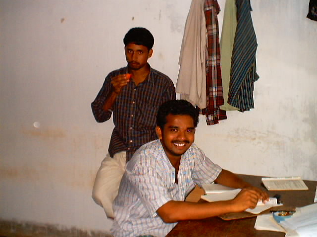 a man sitting next to another man on a table