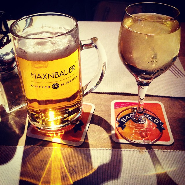 a beverage glass and a beer glass are shown on a table