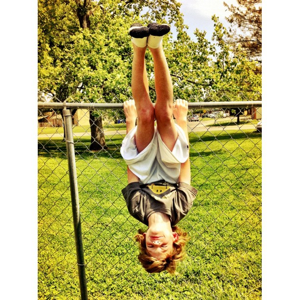 young child upside down on his handstand at park