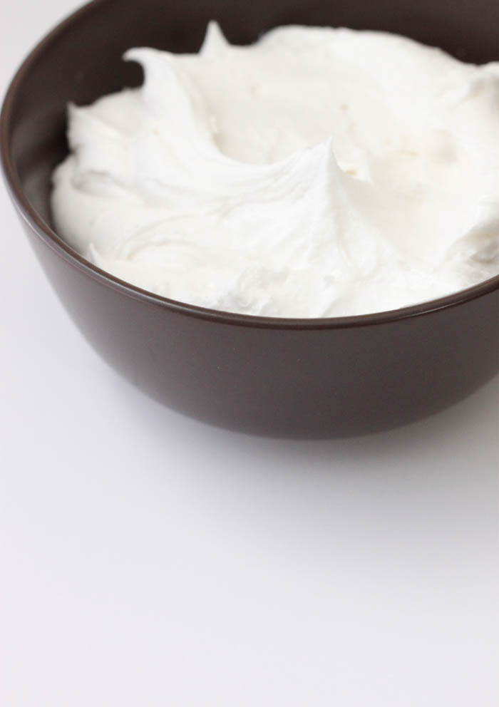 a brown bowl of whipped cream on top of a white counter