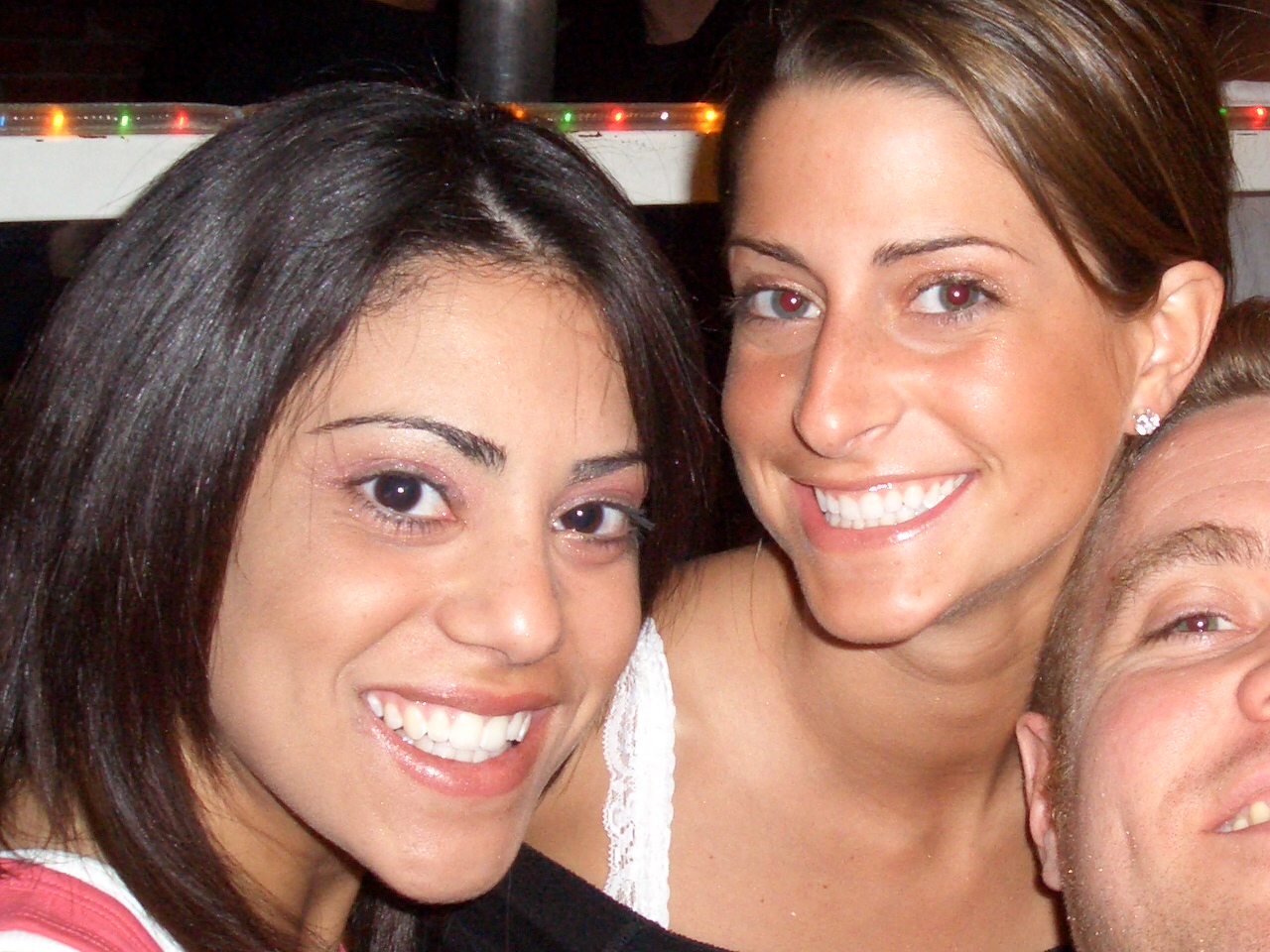 three people are taking a picture together at a bar