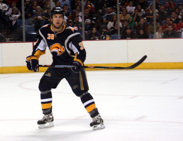 a hockey player standing in front of an audience