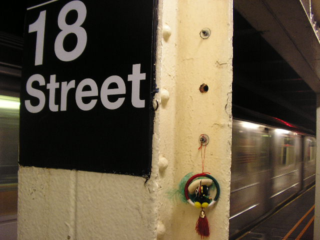 a train passes through a subway tunnel as a sign shows the number 18 street