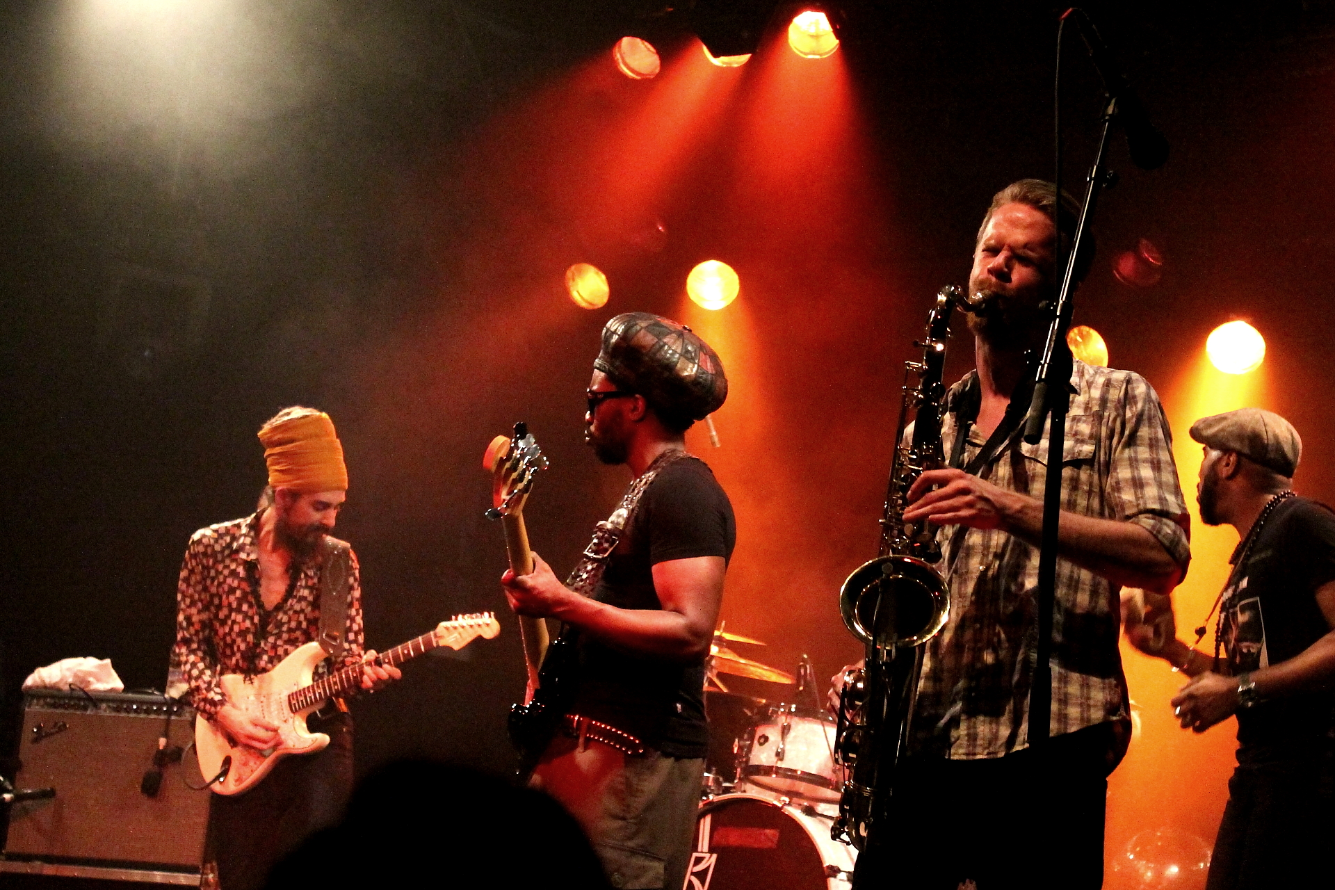 a band performing on stage together on their guitars