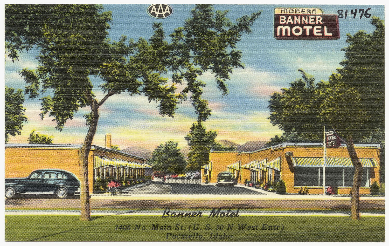 an old pograph of a motel, with cars parked