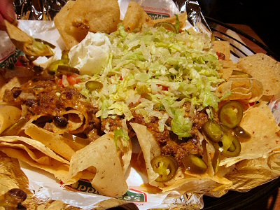 an array of mexican food sits in a basket
