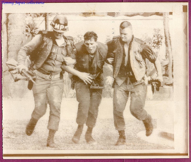 three men in military gear walking past each other