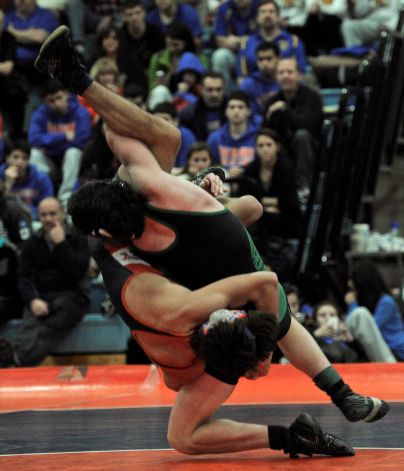 two wrestlers wrestle at a match during a wrestling match