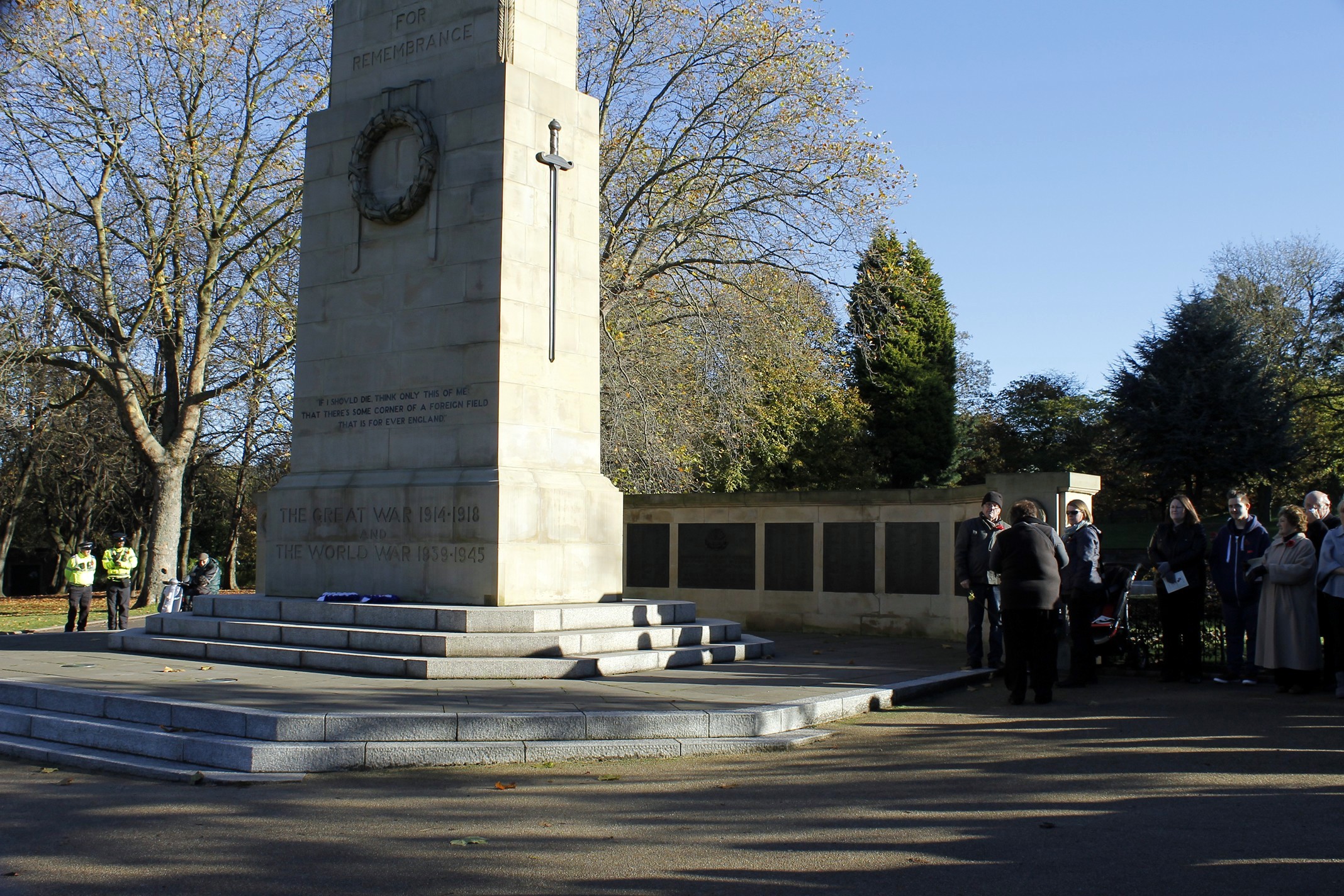 a group of people standing next to a monument