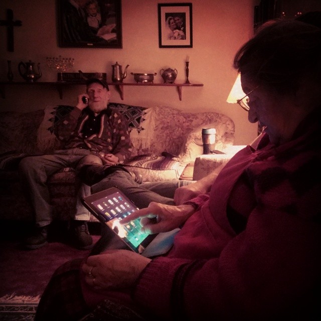 a person that is using a tablet on their couch