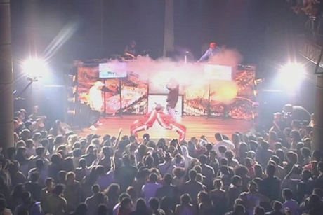 people standing around a concert hall with one man on stage