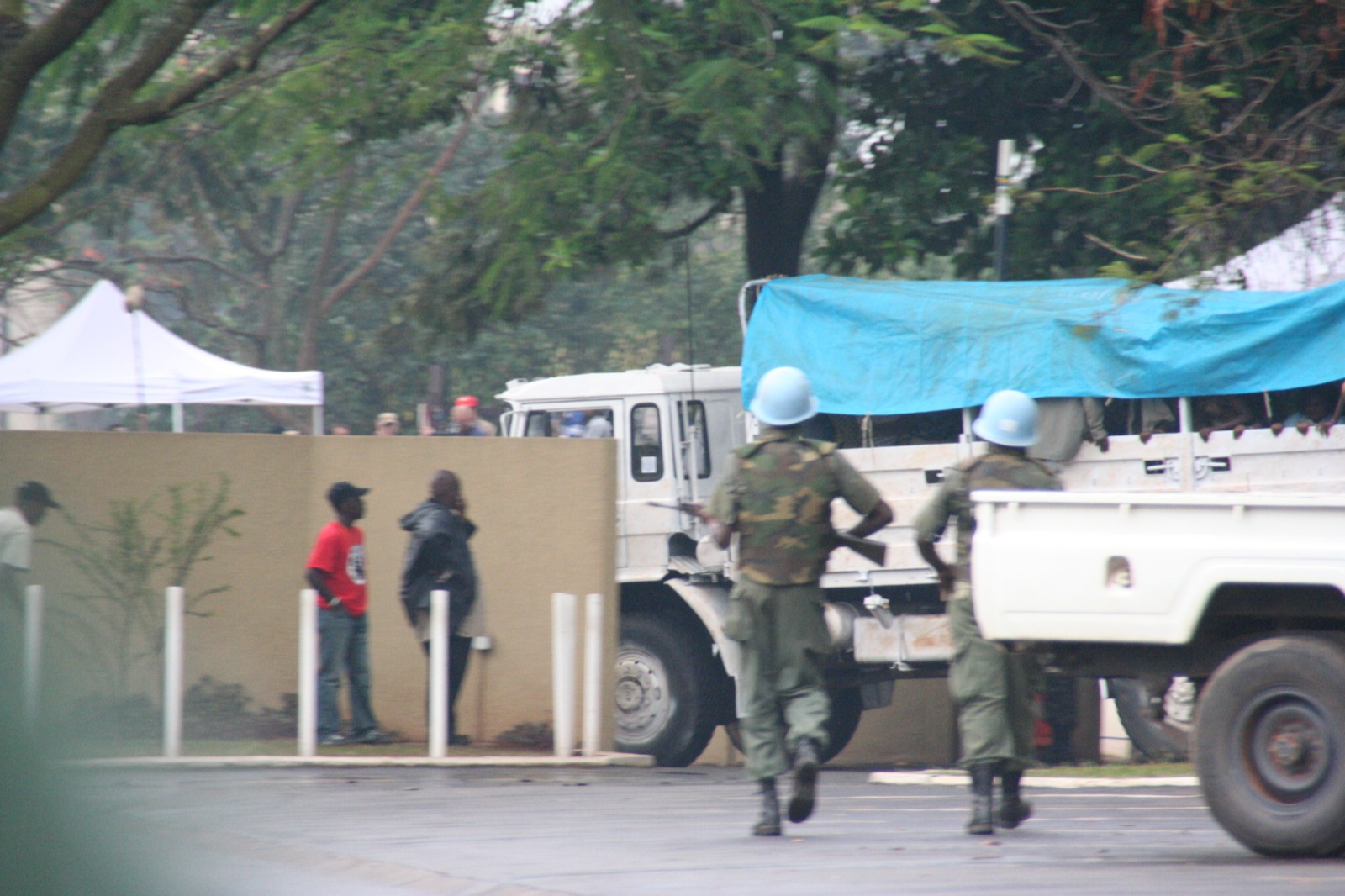 a group of soldiers walking next to a truck