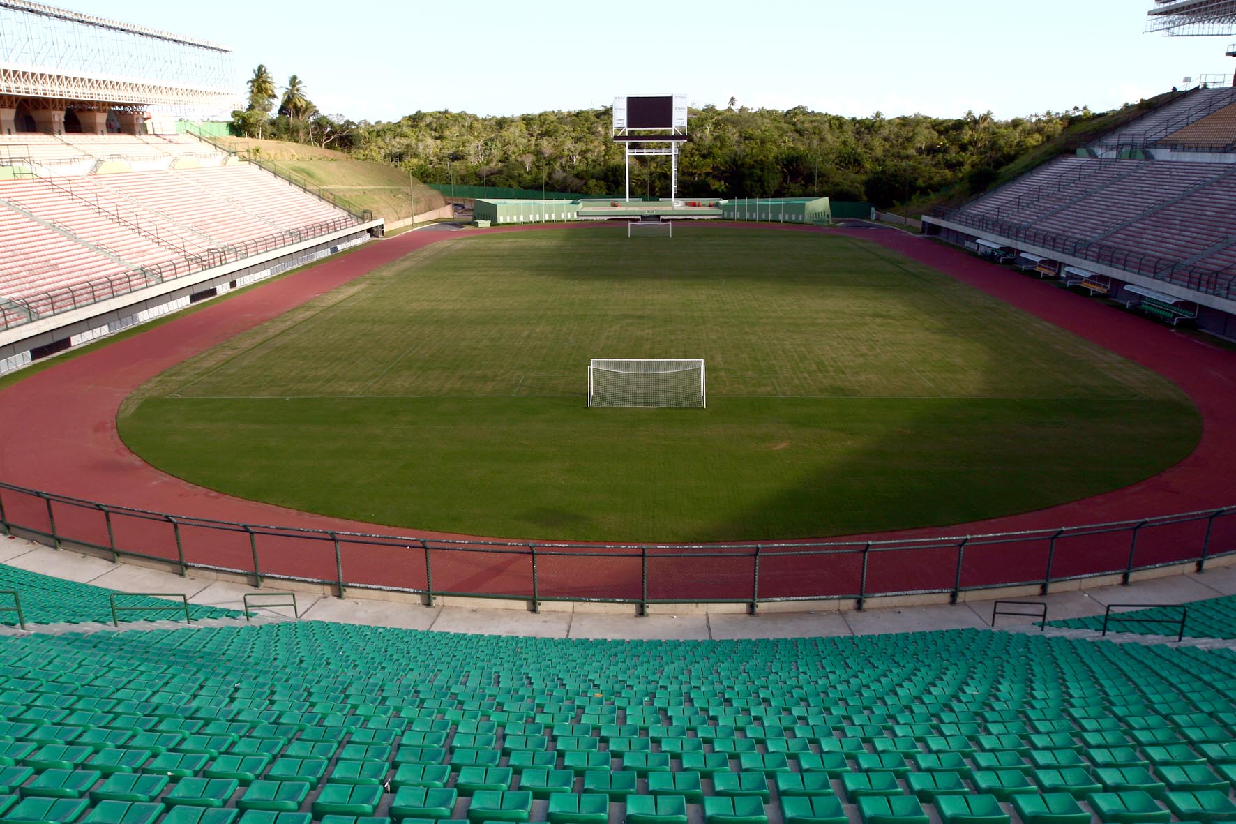 a large soccer field sitting next to a crowd of empty seats
