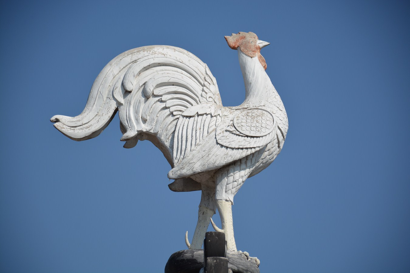 a decorative bird on top of a statue