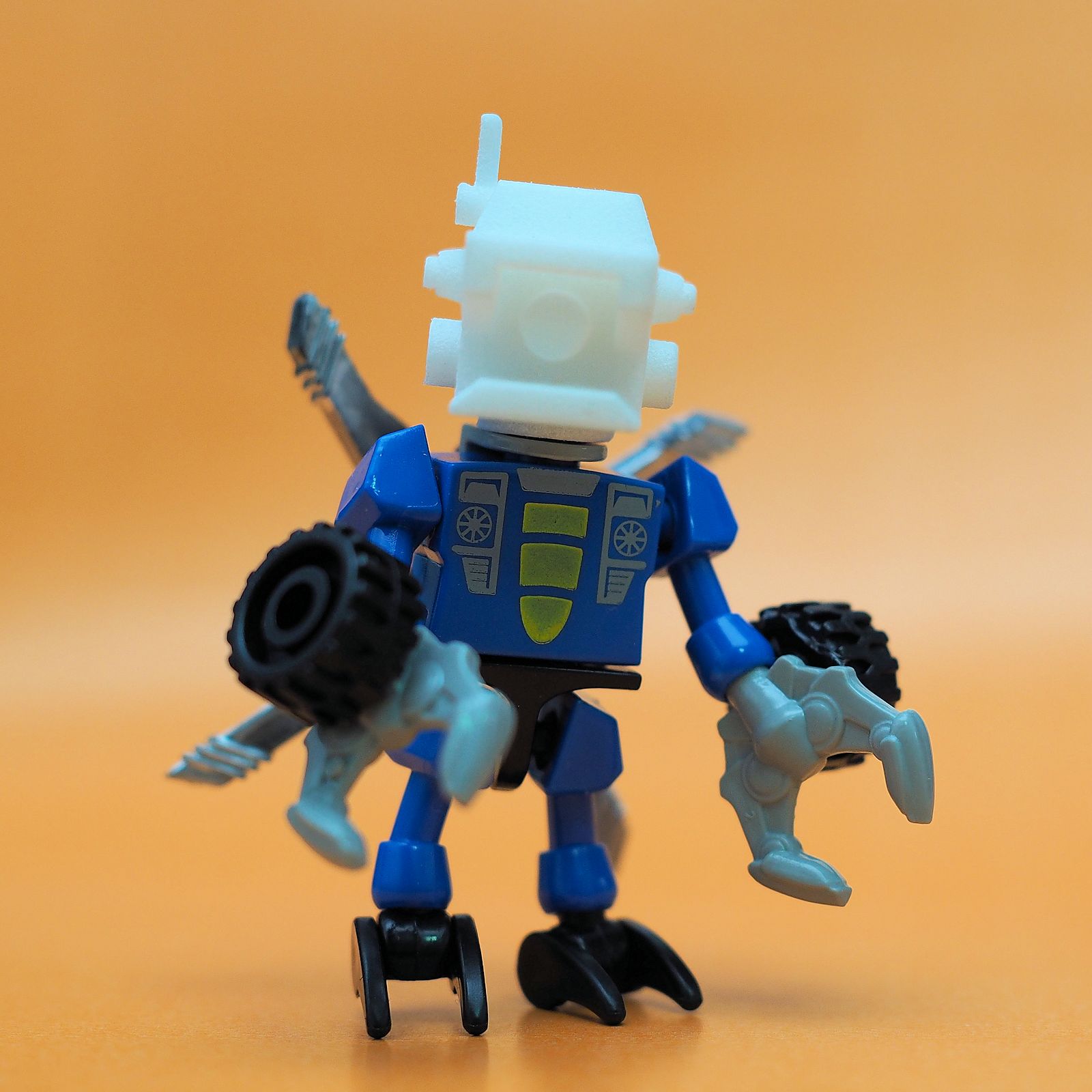 a blue lego figure holding an electrical device