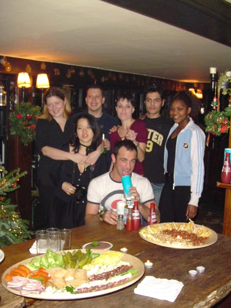 a group of people posing in front of food
