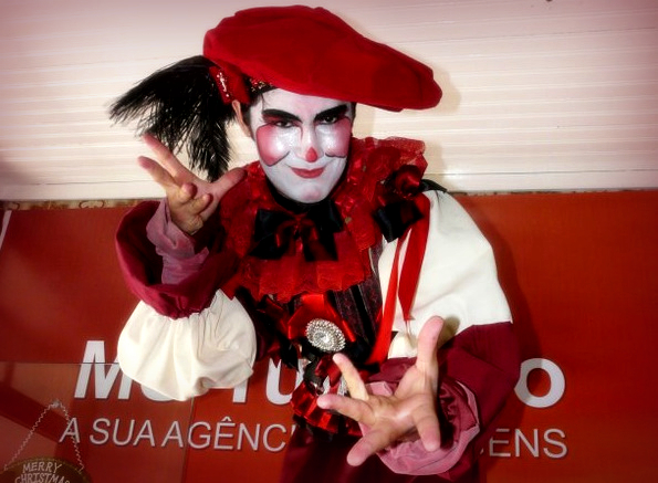 a person dressed in clown costume holding a peace sign