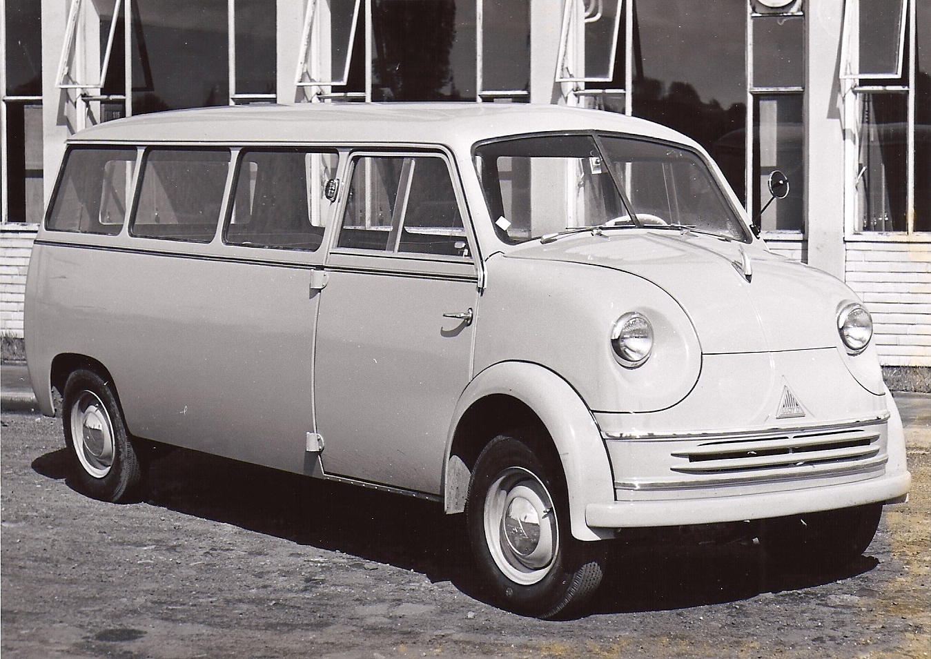 the old car is parked in front of a building