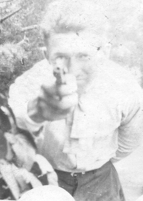 an old pograph of a man in uniform pointing at the camera
