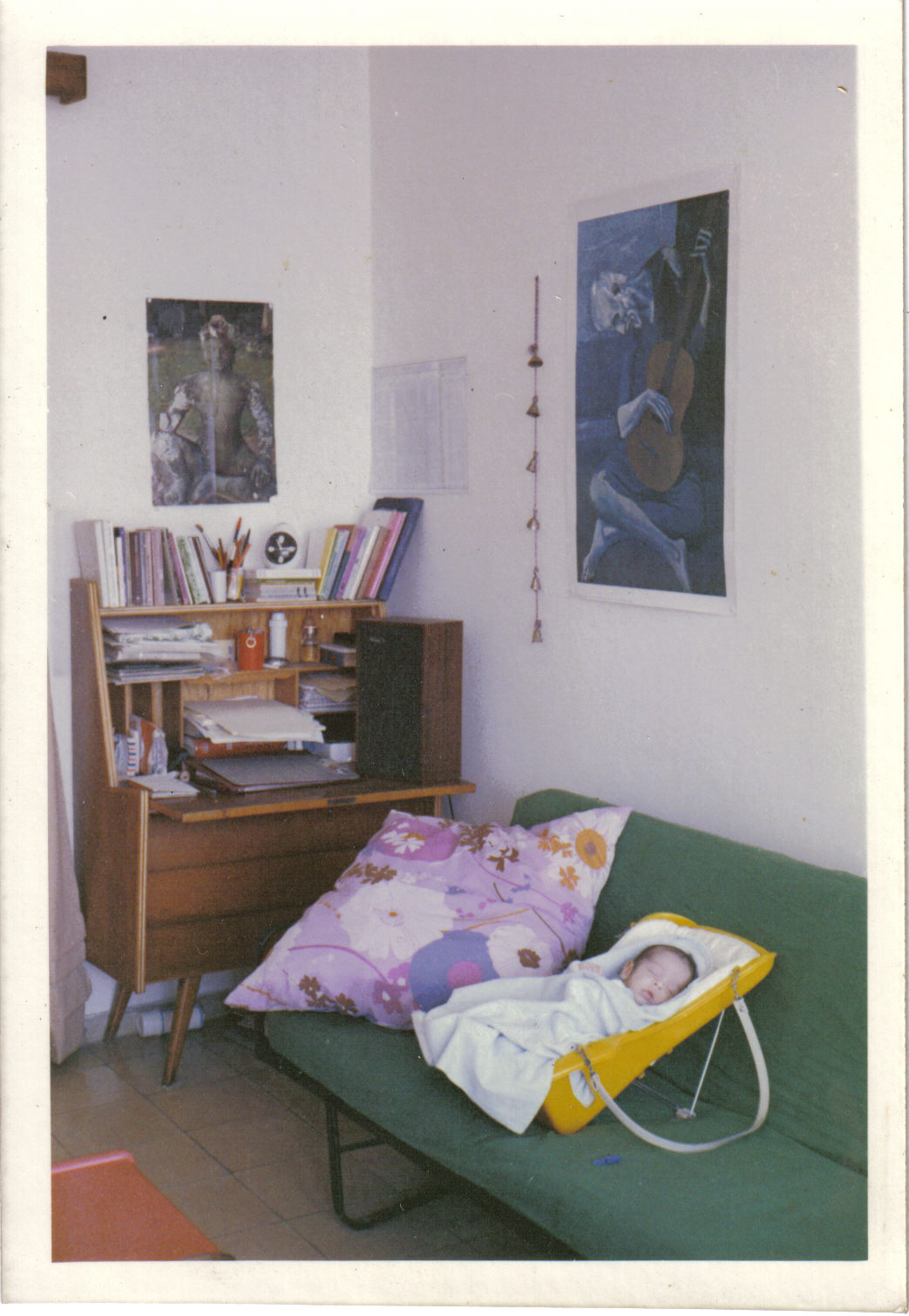 a child snuggling on the futon in a messy room