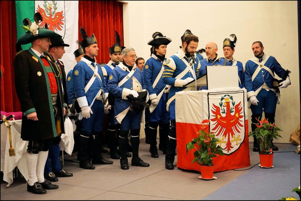 several people standing in uniform and looking at soing