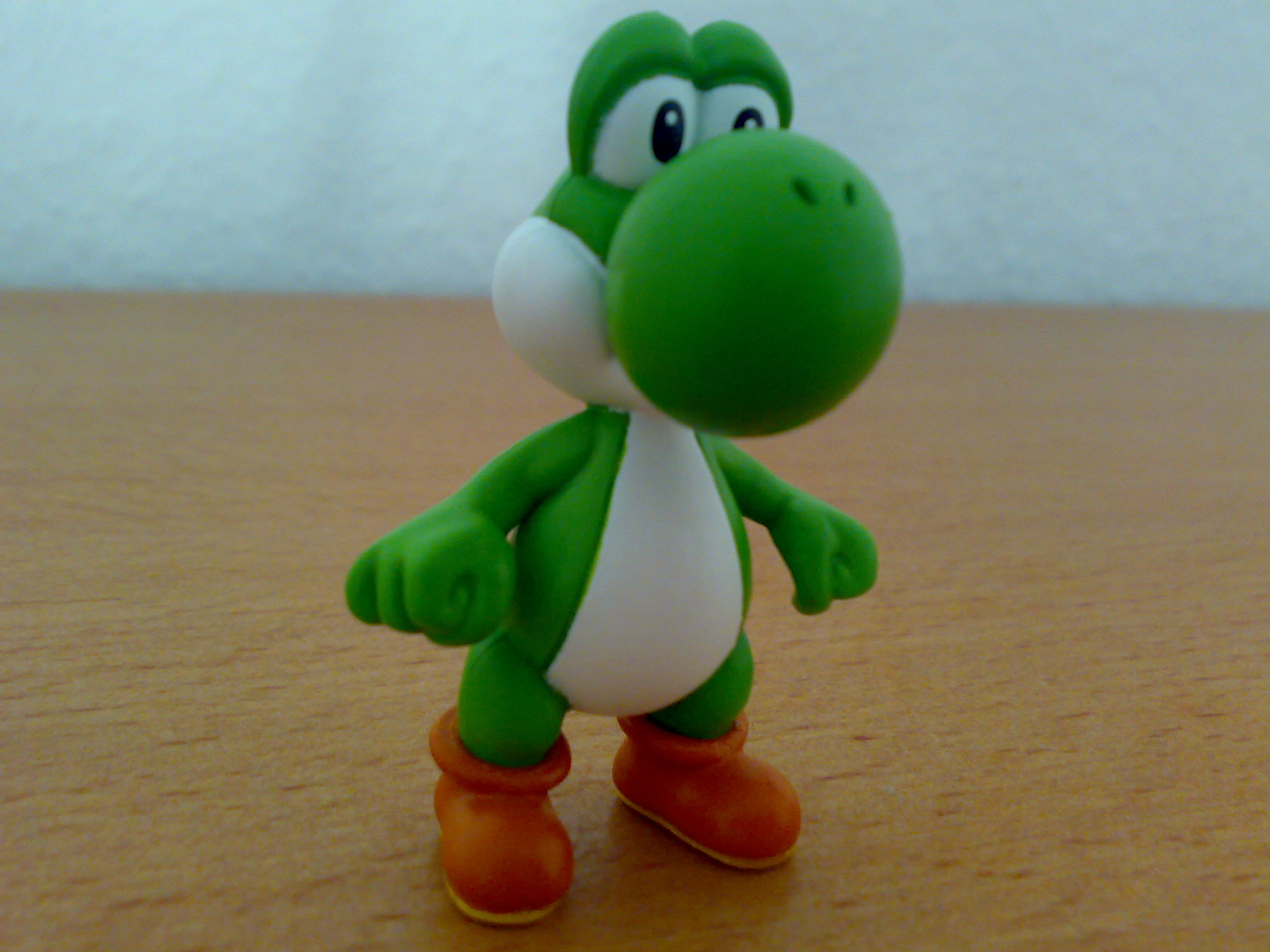 a green and white toy that has a smile on its face
