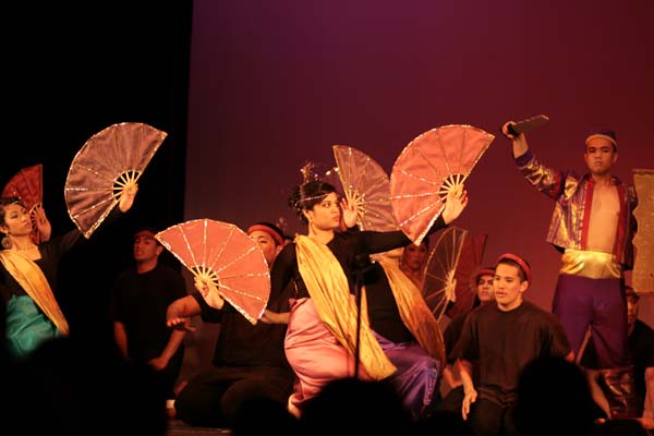 an oriental dance performance, as they are surrounded by other performers