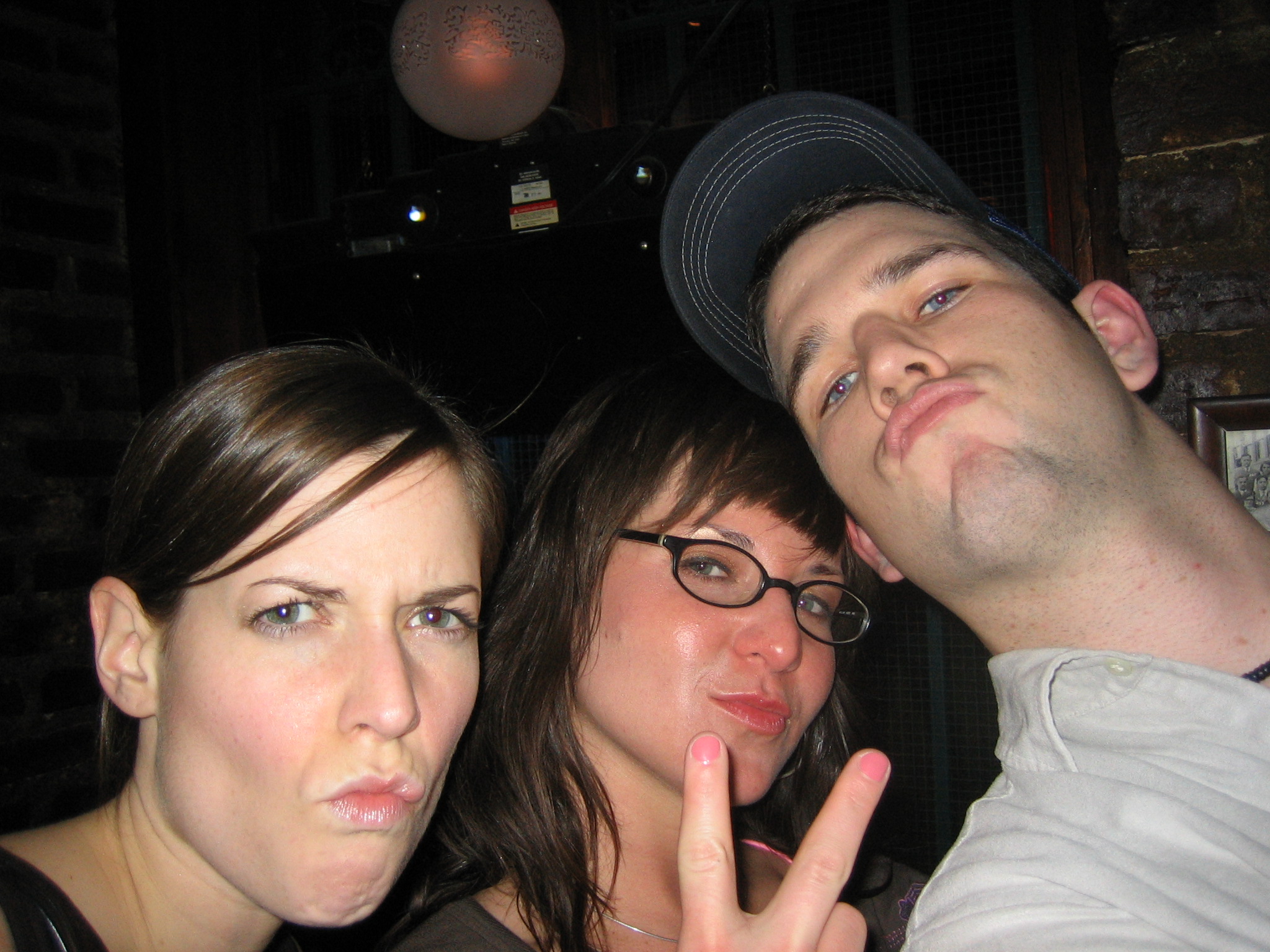 three people making the middle sign with their hands