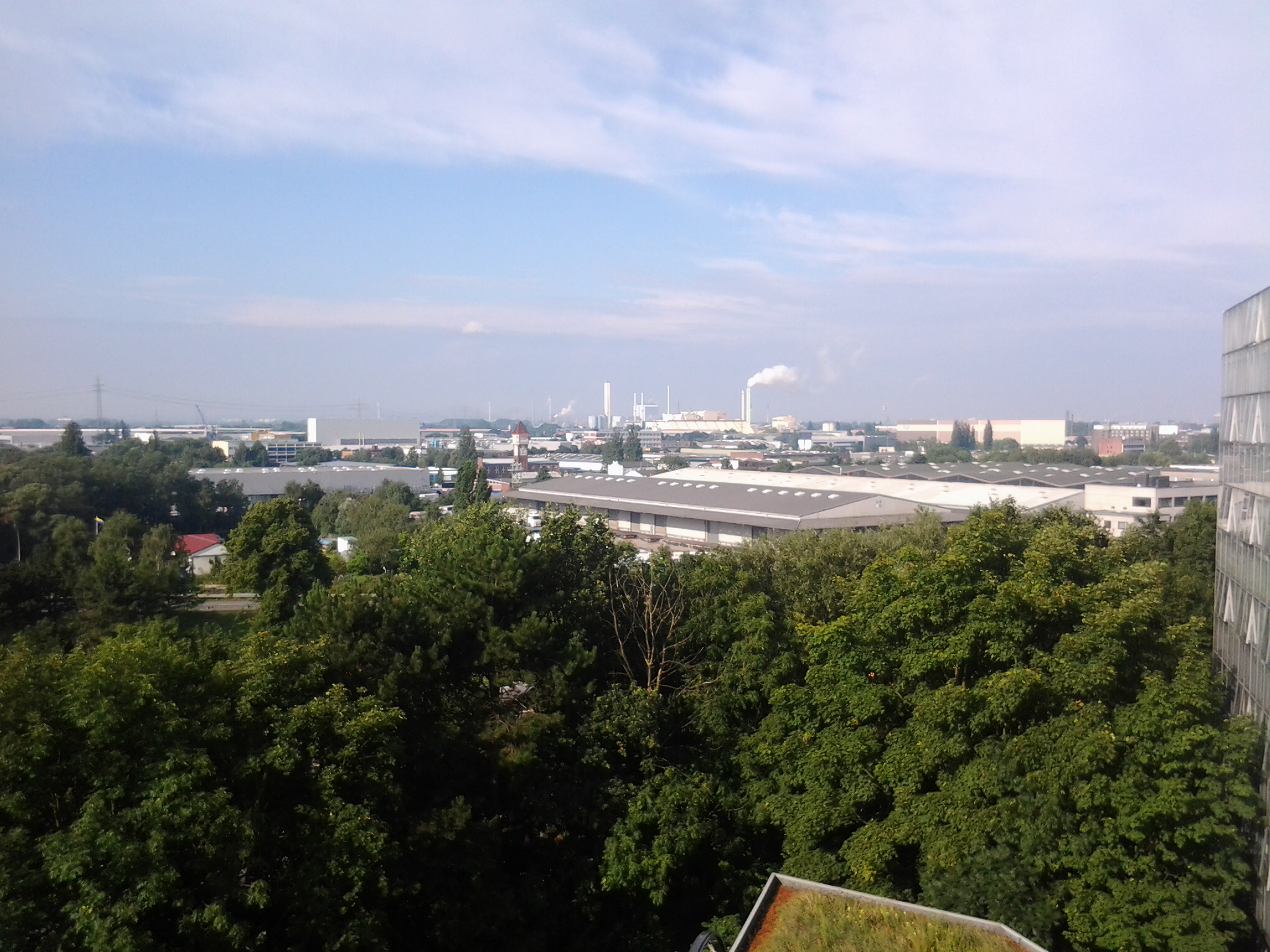 a view from a rooftop looking down on the surrounding area and beyond