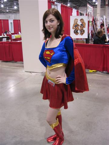 a woman dressed in a superman costume is standing