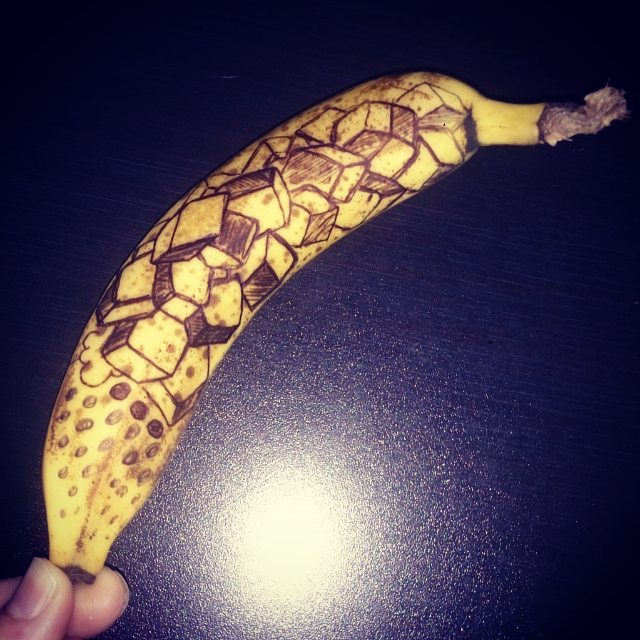 a yellow banana that has been decorated with black spots