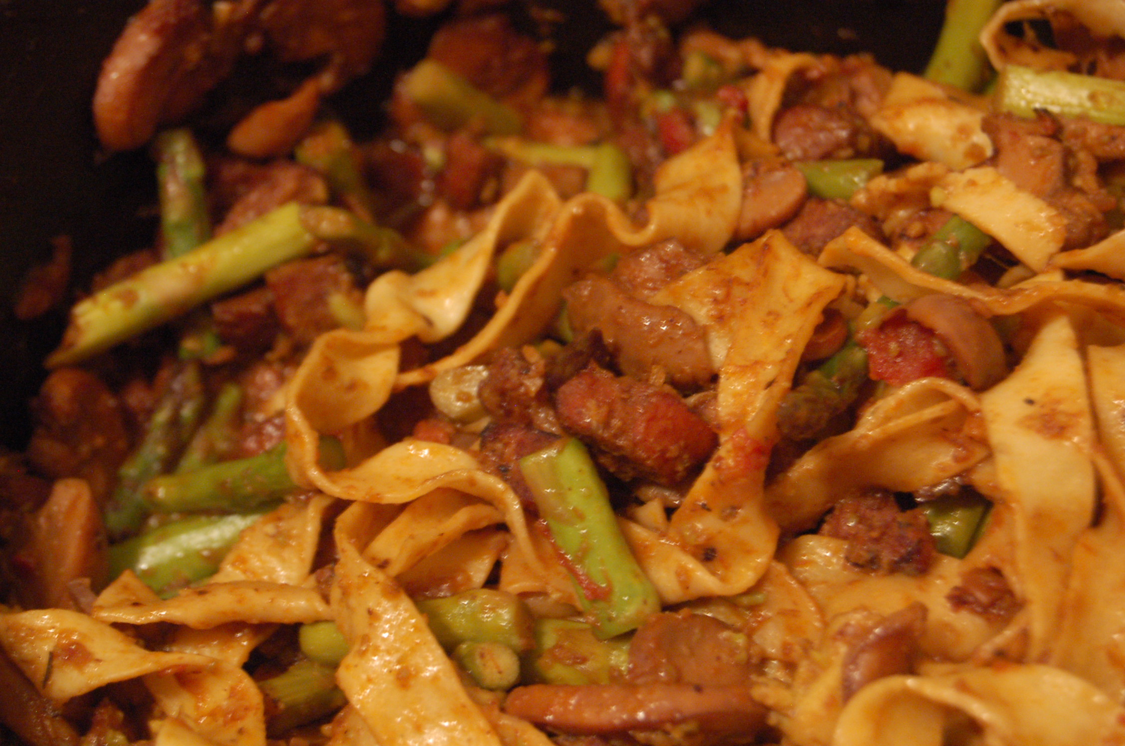 the pasta is cooked in a pot with asparagus