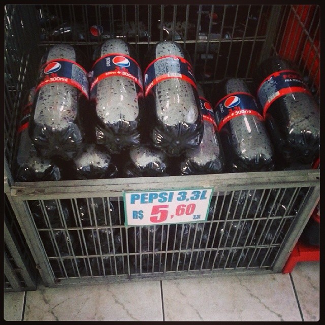 there is a bunch of pepsi sodas in a cage