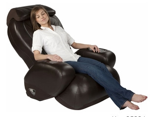 a woman sitting in a brown recliner with her feet up and smiling