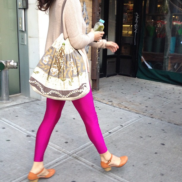 a young woman in high heel shoes carrying a purse