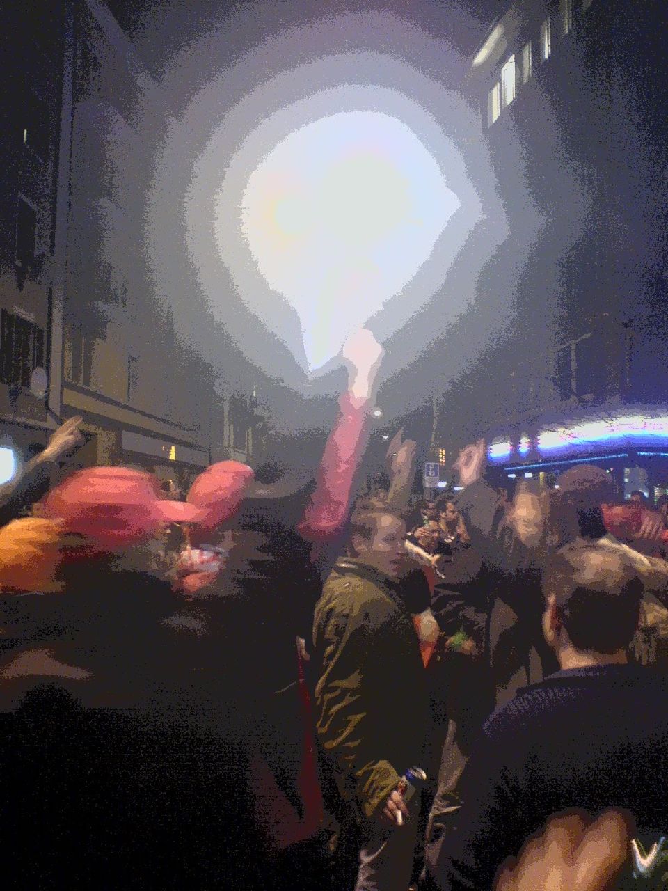 a blurry image of a crowd of people dancing