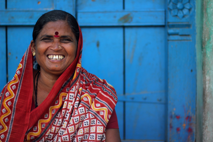 a woman smiling wearing a red neck tie